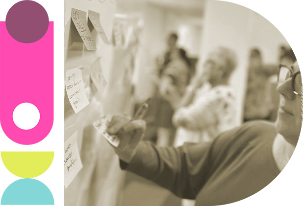 A CICan staff member writes notes on a board at a workshop
