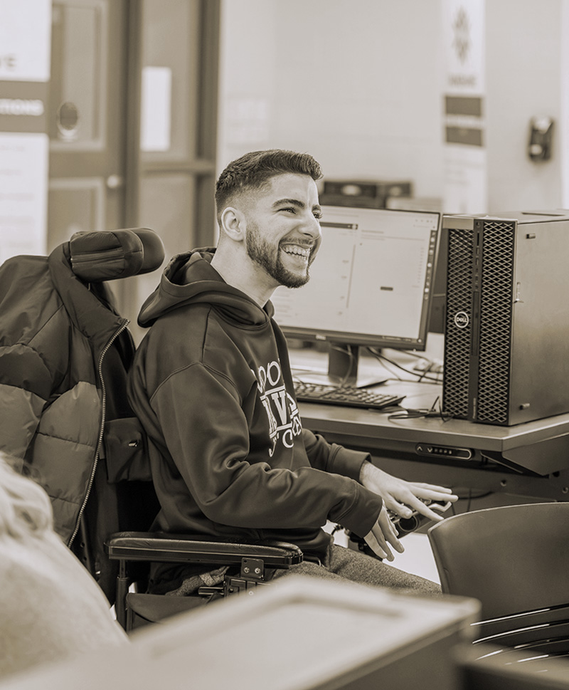 A student in a wheelchair uses a computer